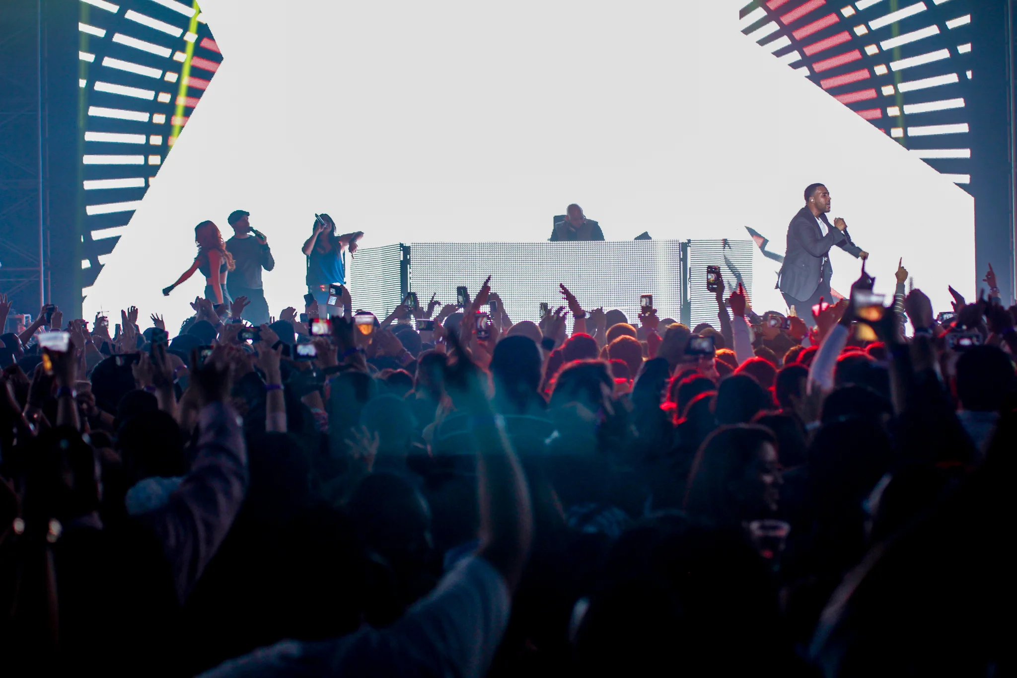 Large outdoor festival audience facing a live stage